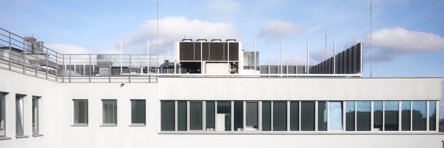 Commercial office building rooftop with mechanical units and flat roof system in New York