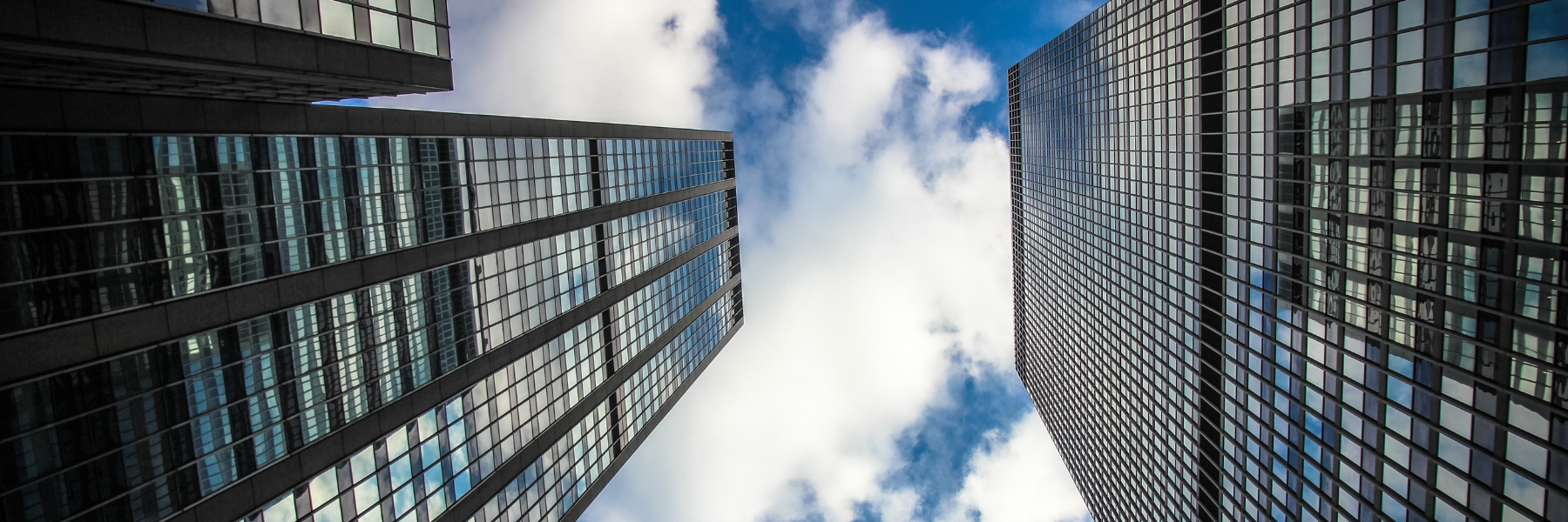 Modern glass office buildings viewed from street level in an urban commercial district