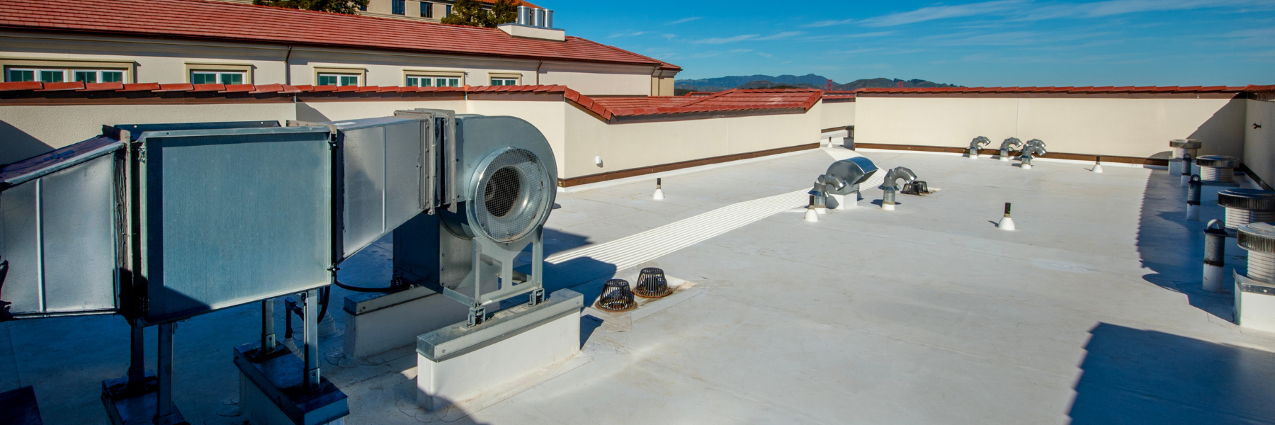 Commercial rooftop edge with city skyline in the background