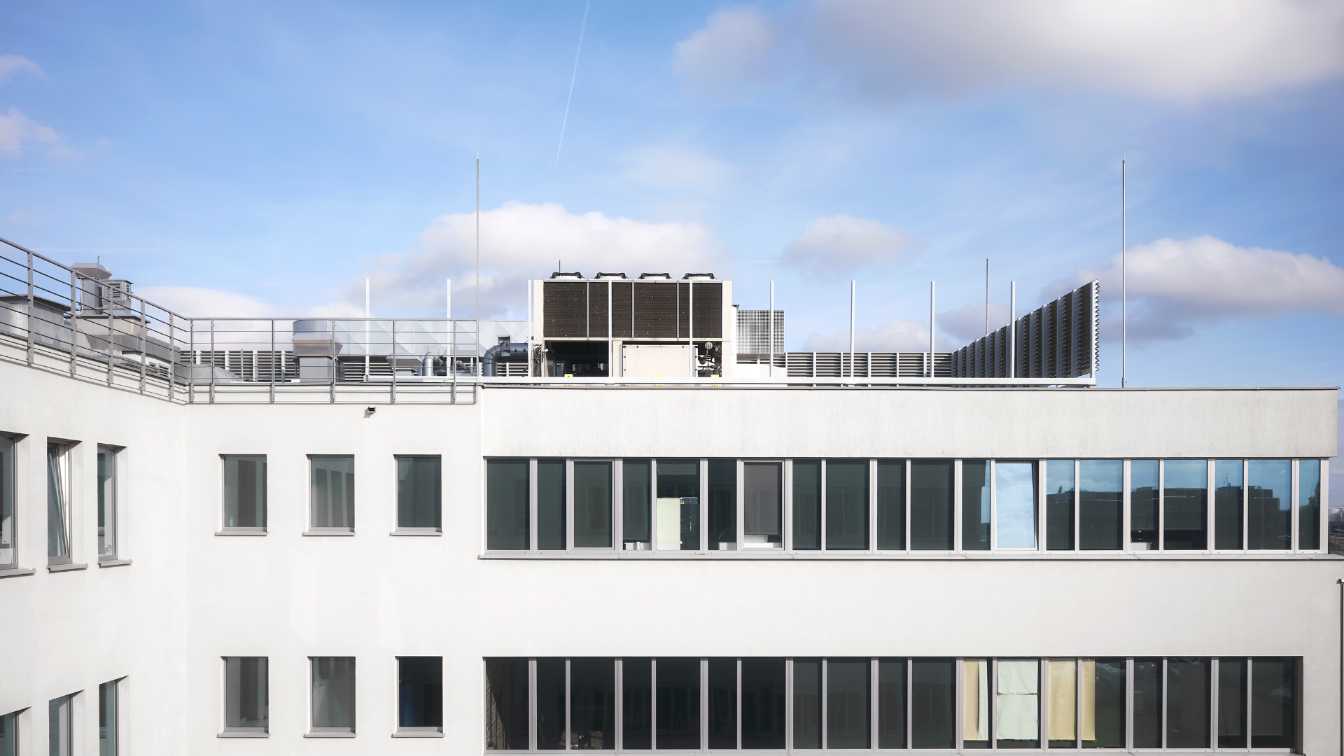 Commercial office building rooftop with mechanical units and flat roof system in New York